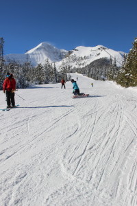 Snowboard instructor Mary Gandy carving up the groomer under bluebird skies