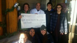 Olive B's restaurant donated $7,000 to LPHS Interact Club from a Dec. 7 benefit dinner. The money will be used for the club's trip to Nepal in March, where they will volunteer with Tsering's Fund. Olive B's owners Jennie and Warren "Bibber" Bibbins (top left) present the donation to members of the Interact Club. PHOTO BY DALE PALMER